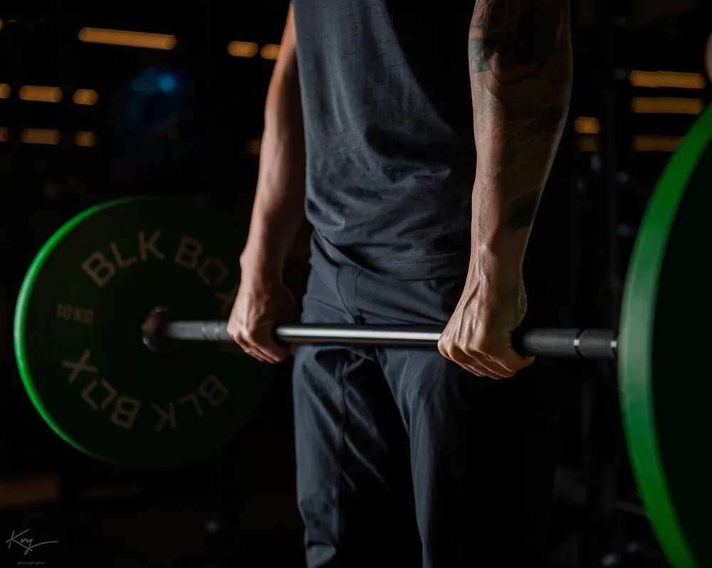 Close up of hands gripping a barbell for deadlift